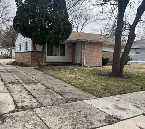 a view of a house with a tree in the yard