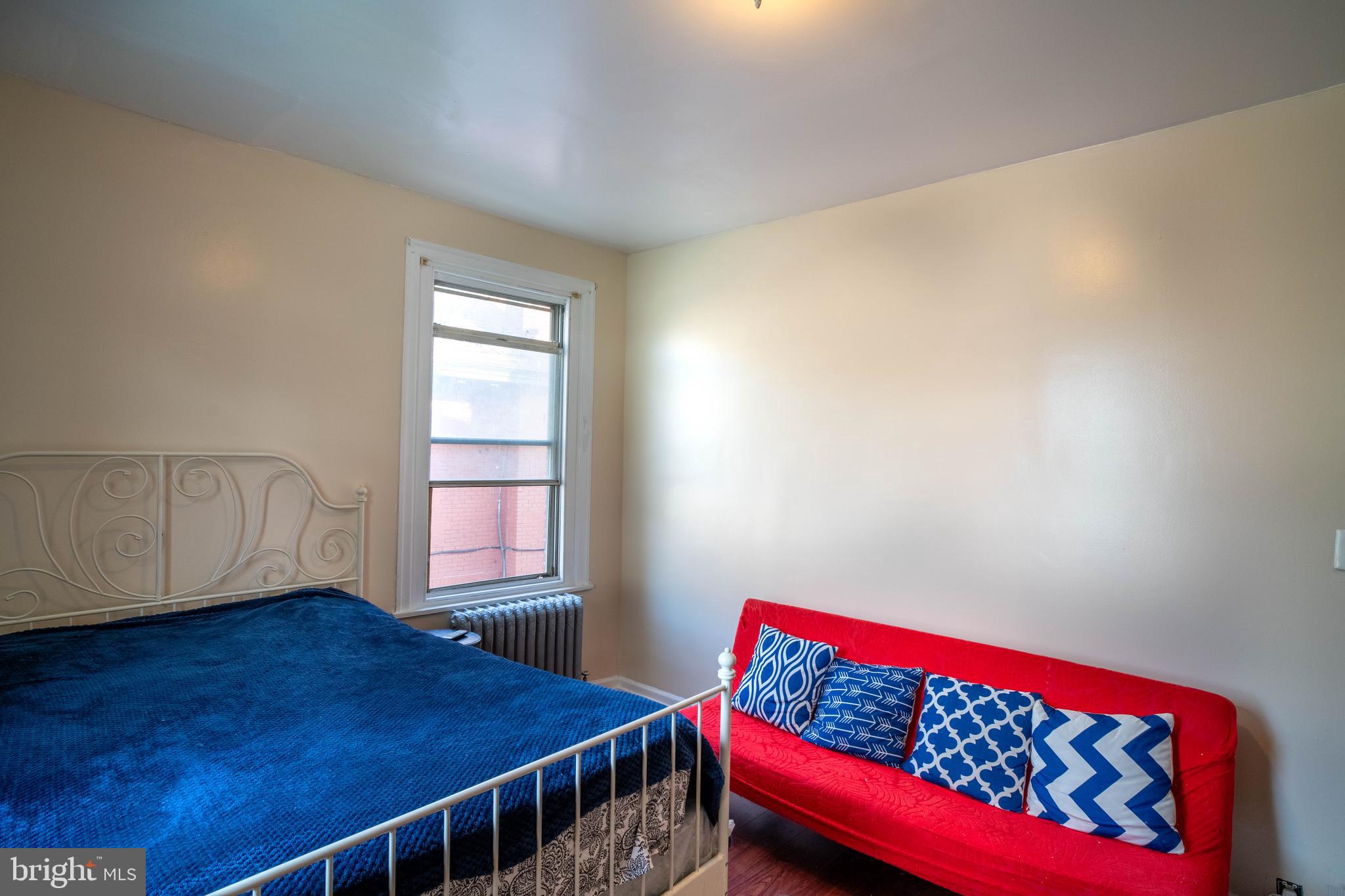 1227 Harrison Street Philadelphia, PA 19124 - Photo 16 of 38 a bedroom with a bed and a window