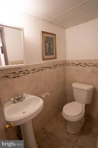 a bathroom with a sink a toilet and mirror