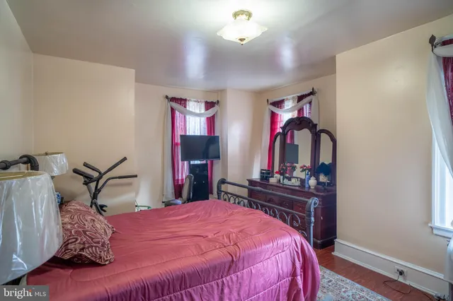 a bed room with a bed mirror and a desk