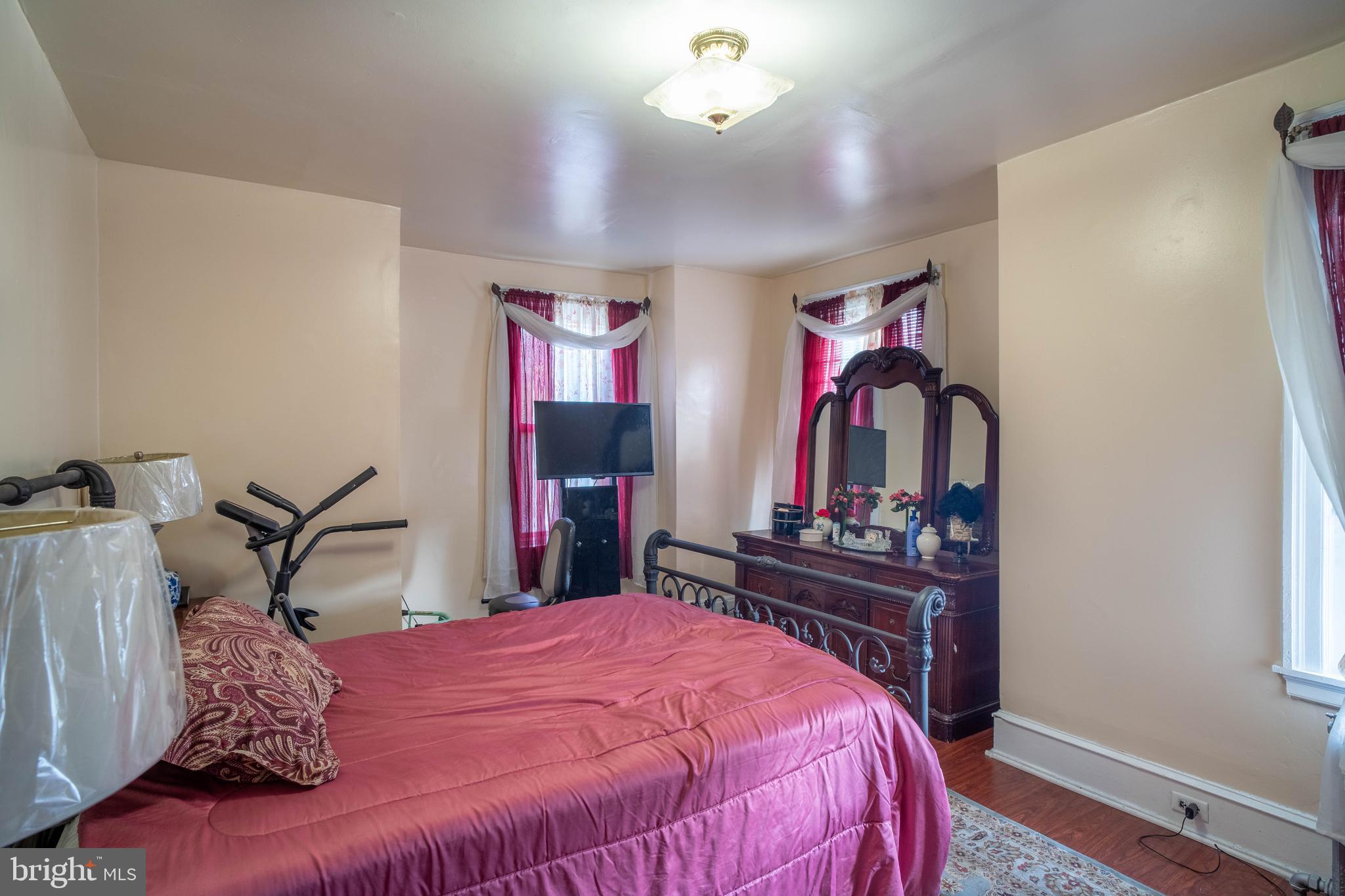 1227 Harrison Street Philadelphia, PA 19124 - Photo 26 of 38 a bed room with a bed mirror and a desk