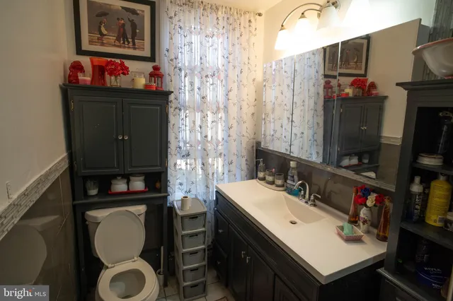 a bathroom with a sink vanity and a mirror