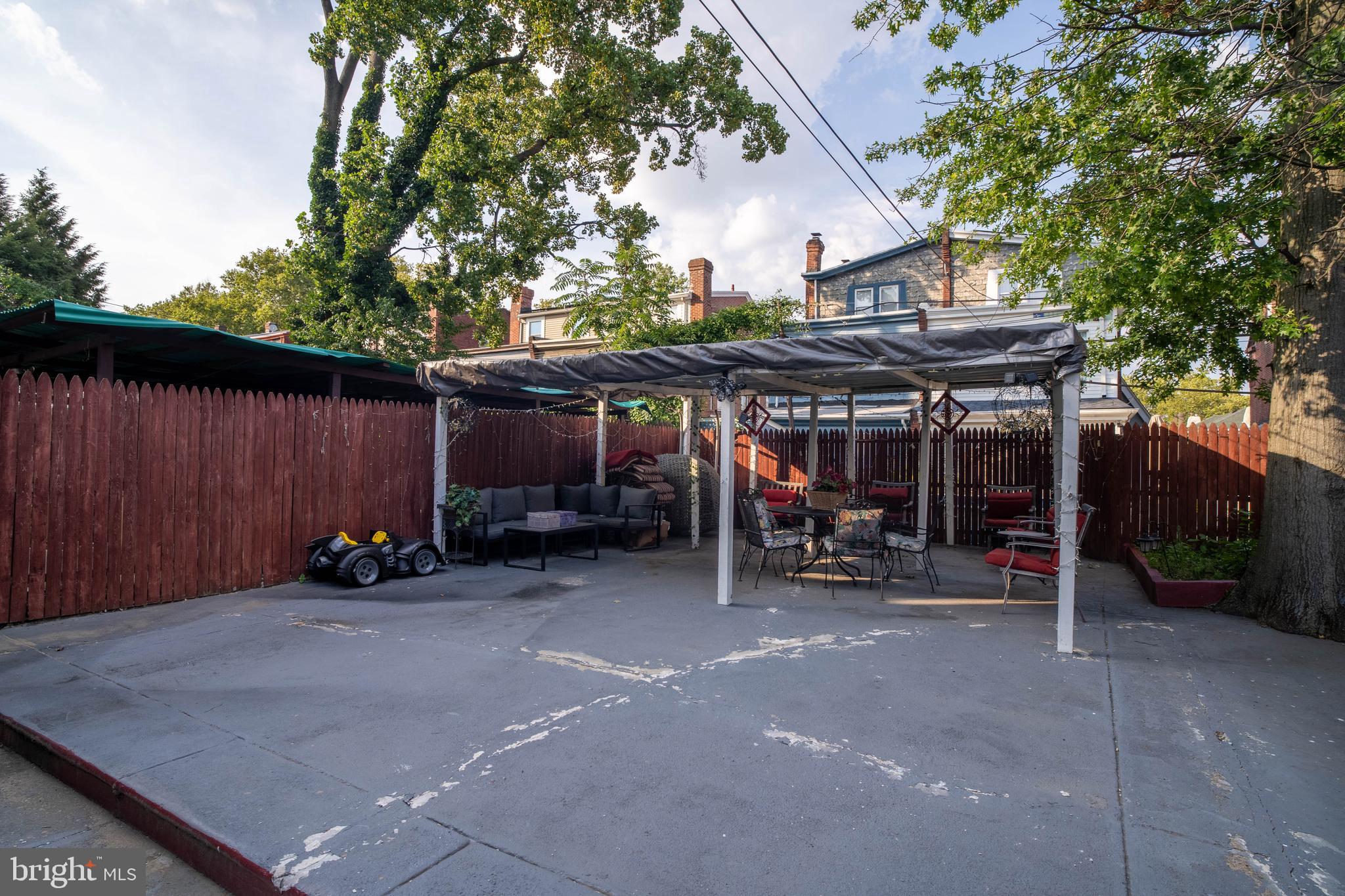 1227 Harrison Street Philadelphia, PA 19124 - Photo 35 of 38 a view of a building with a table and chairs under an umbrella