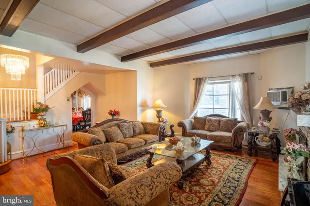a living room with furniture fireplace and a large window