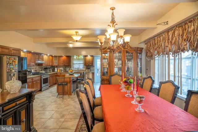 a dining room with furniture a chandelier and wooden floor
