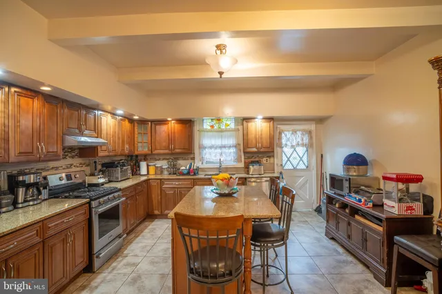a kitchen with stainless steel appliances a stove a sink dishwasher and cabinets with wooden floor
