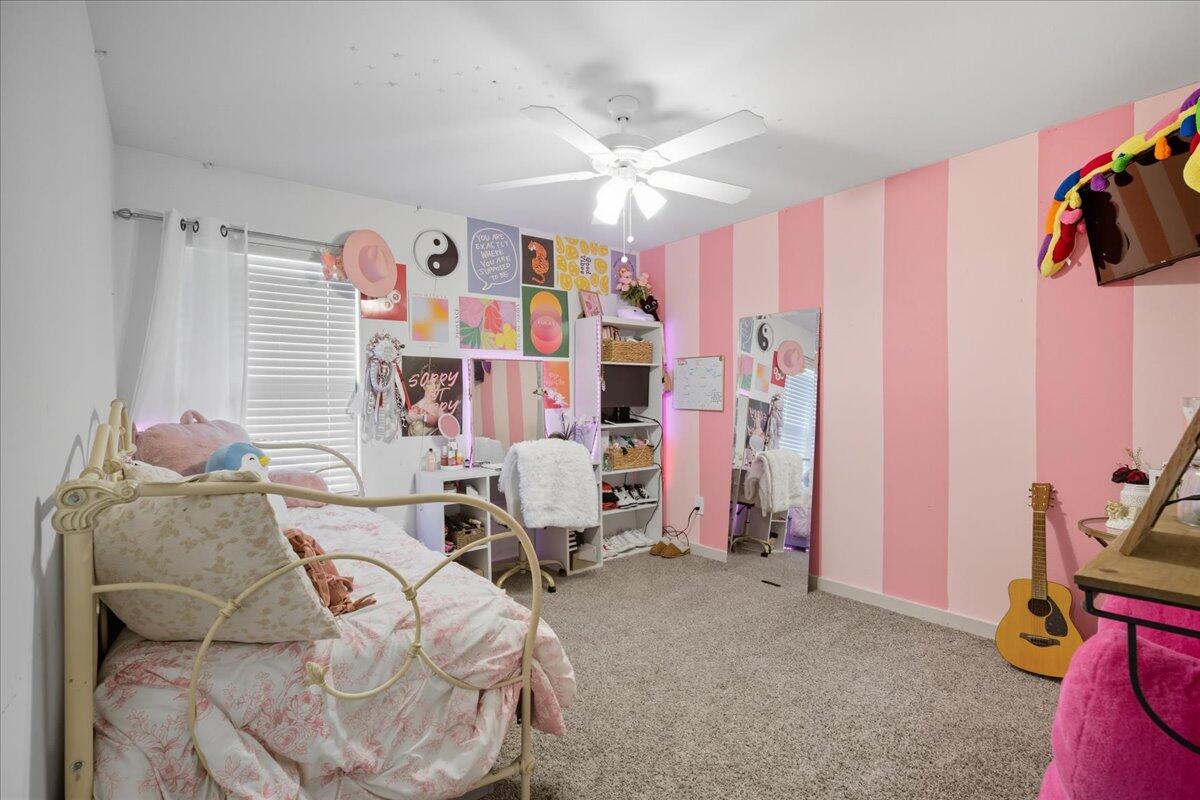 2309 149th Street Lubbock, TX 79423 - Photo 11 of 31 a living room with furniture and a flat screen tv