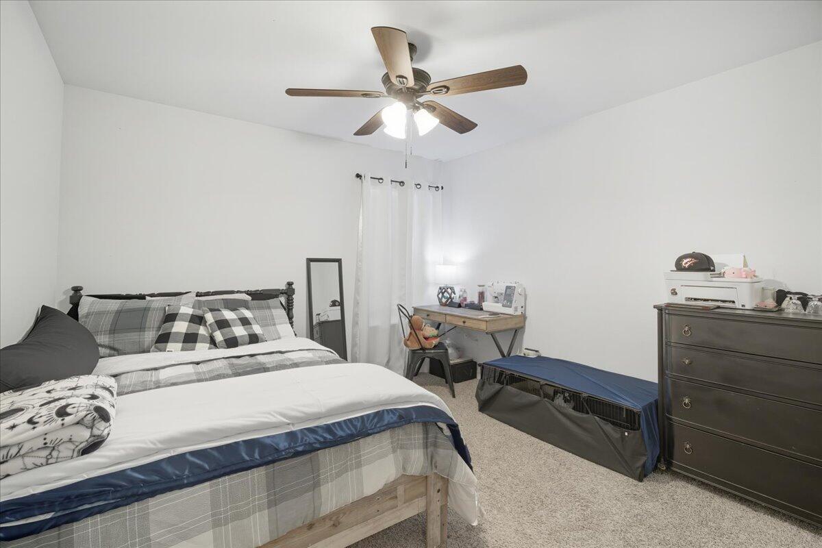 2309 149th Street Lubbock, TX 79423 - Photo 13 of 31 a bedroom with a bed and a table in it