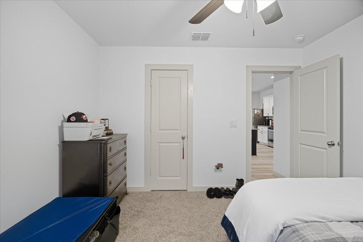 2309 149th Street Lubbock, TX 79423 - Photo 14 of 31 a bedroom with a bed and a dresser