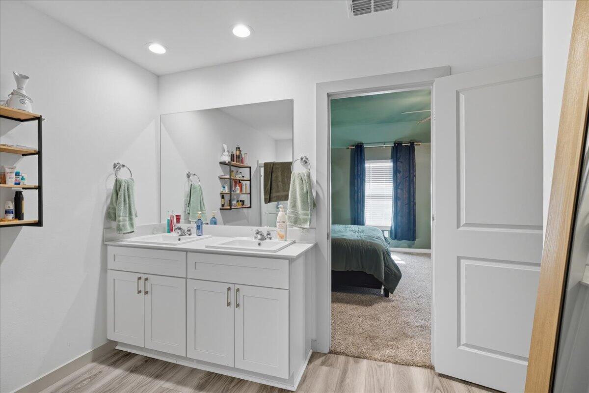2309 149th Street Lubbock, TX 79423 - Photo 18 of 31 a en suite bathroom with 2 sink and a mirror