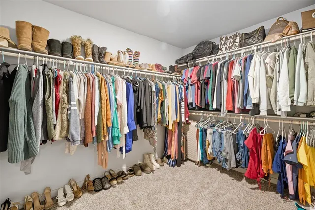 a view of walk in closet with clothes