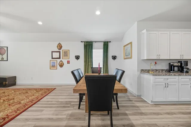 a dining room with furniture and wooden floor