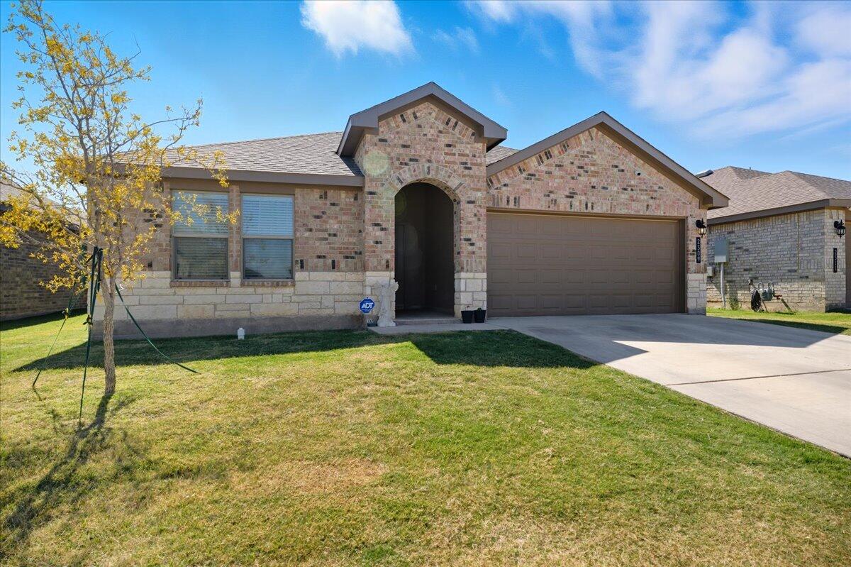 2309 149th Street Lubbock, TX 79423 - Photo 2 of 31 a front view of a house with garden