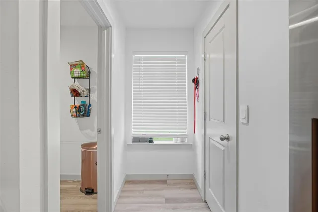 a view of hallway with wooden floor