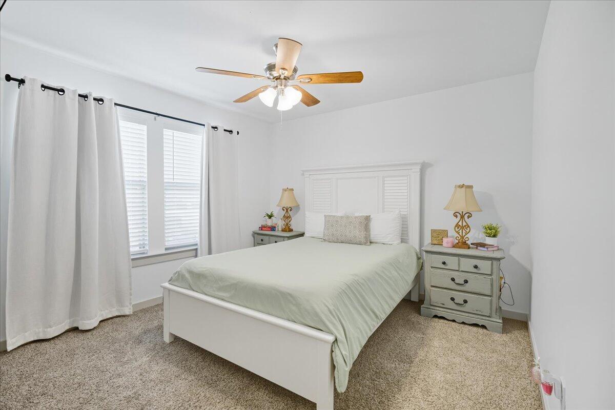 2309 149th Street Lubbock, TX 79423 - Photo 7 of 31 a bedroom with a bed and a chandelier