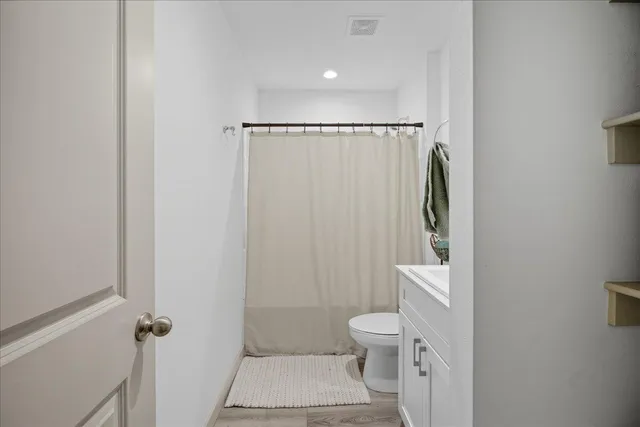 a bathroom with a toilet and a shower