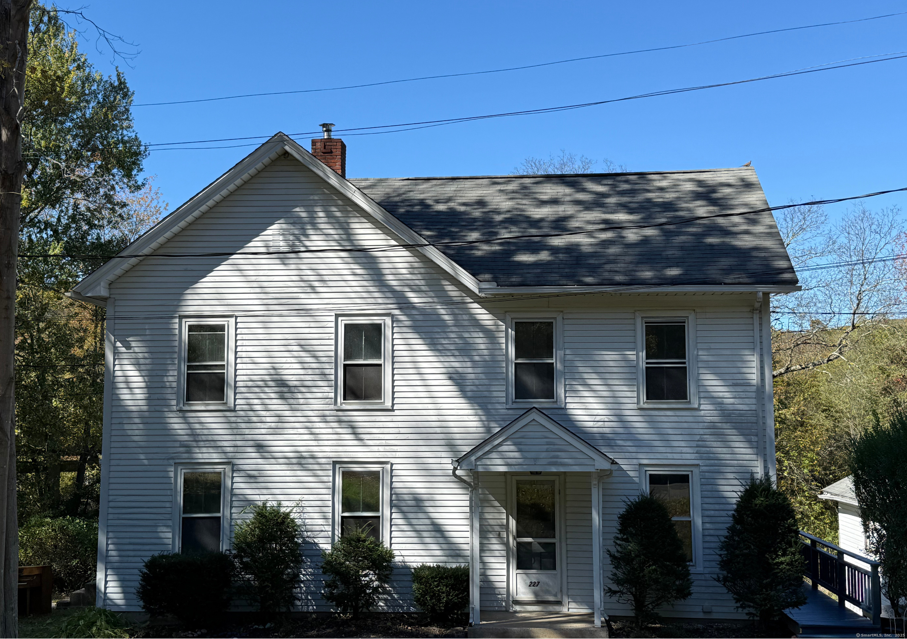 227 Railroad Street, Unit 2 Thomaston, CT 06787 - Photo 1 of 1 a view of a house with brick walls and potted plants