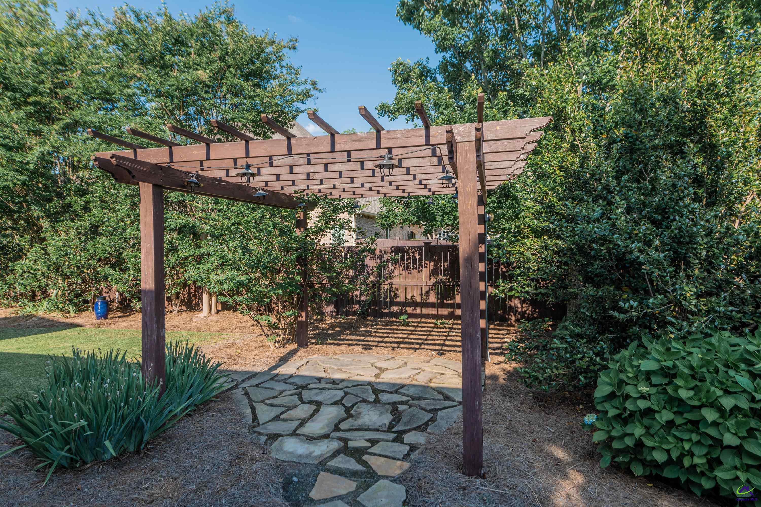 405 Old Bridge Road Warner Robins, GA 31088 - Photo 54 of 58 a view of a yard with plants and wooden fence