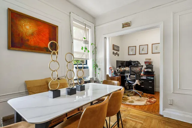 a view of a dining room with furniture and wooden floor