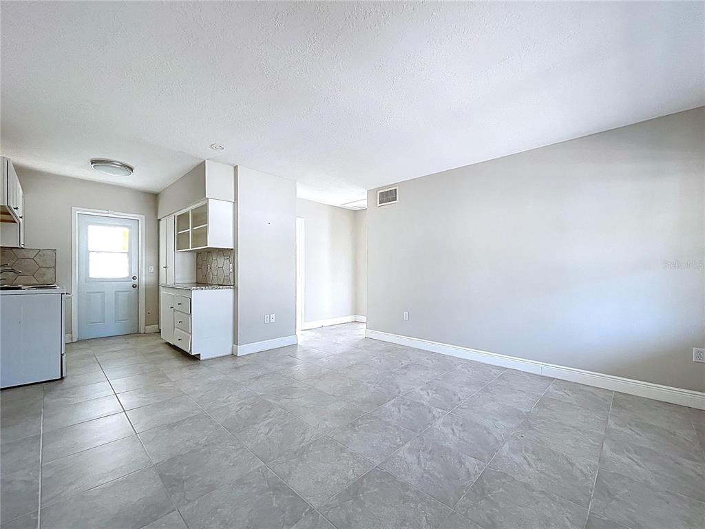 501 Spring Avenue Anna Maria, FL 34216 - Photo 11 of 49 a view of a kitchen with refrigerator and white cabinets