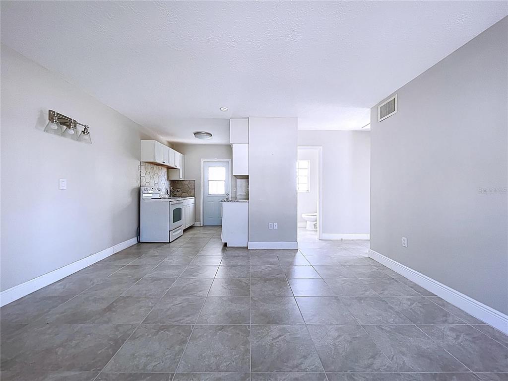 501 Spring Avenue Anna Maria, FL 34216 - Photo 12 of 49 a view of a kitchen with furniture and an empty room