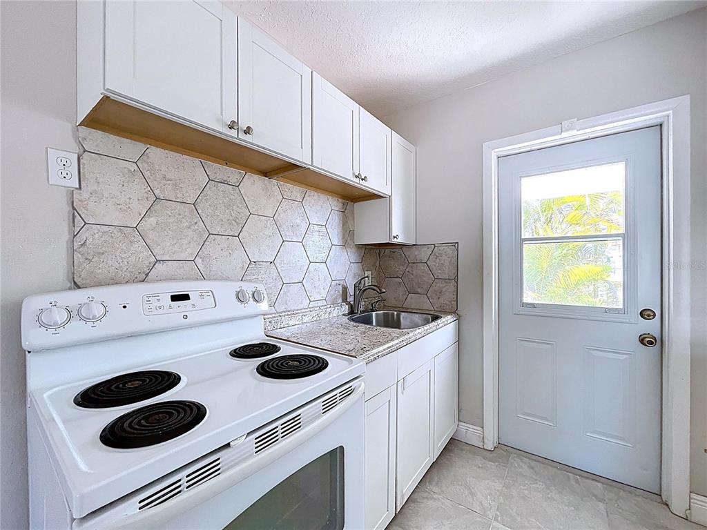 501 Spring Avenue Anna Maria, FL 34216 - Photo 13 of 49 a kitchen with a stove and a sink