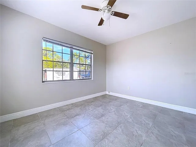 an empty room with windows and closet