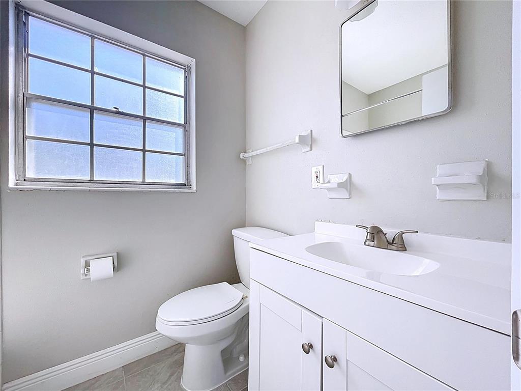 501 Spring Avenue Anna Maria, FL 34216 - Photo 22 of 49 a bathroom with a sink a toilet and a mirror