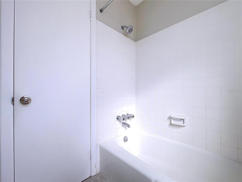 501 Spring Avenue Anna Maria, FL 34216 - Photo 23 of 49 a bathroom with a bathtub and shower