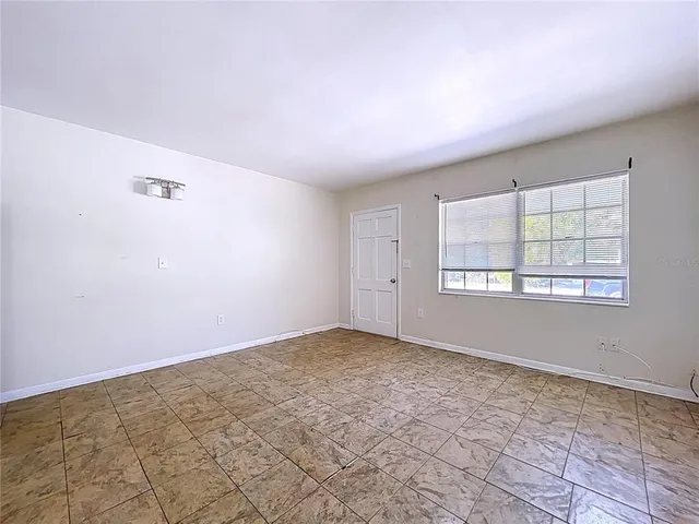 a view of a kitchen with refrigerator and wooden floor