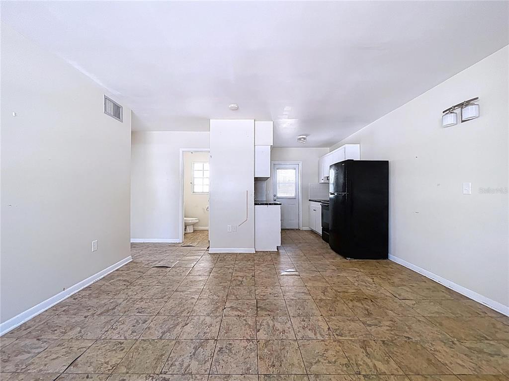 501 Spring Avenue Anna Maria, FL 34216 - Photo 28 of 49 a view of a kitchen with refrigerator and wooden floor