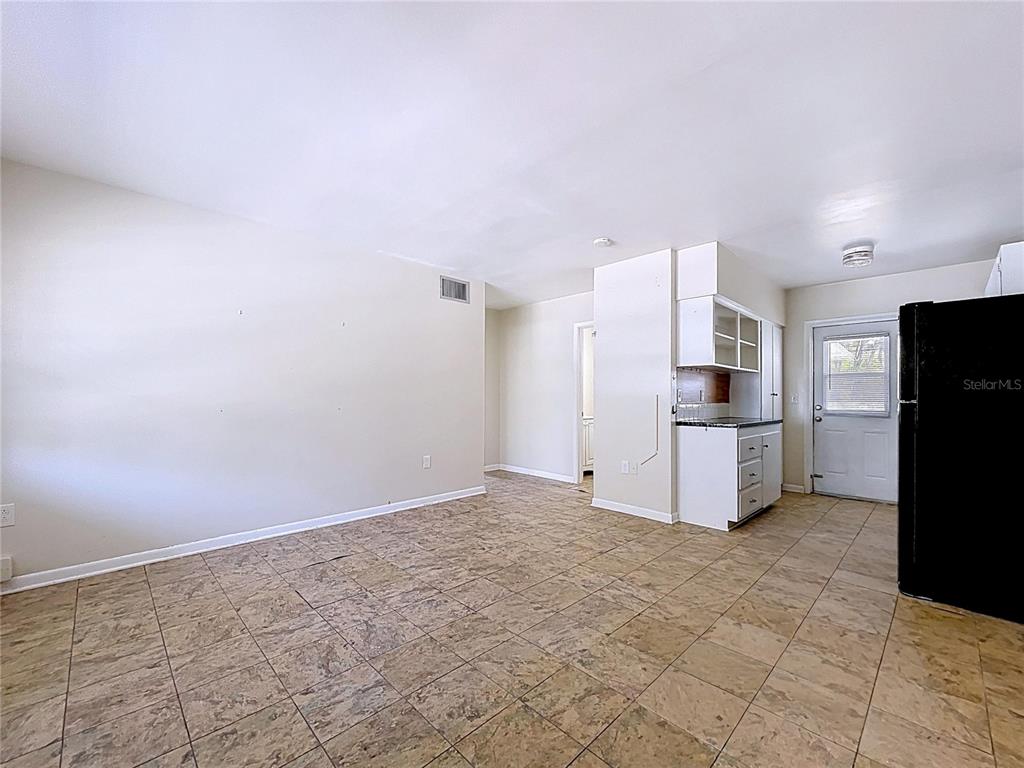 501 Spring Avenue Anna Maria, FL 34216 - Photo 29 of 49 a view of kitchen with refrigerator cabinets and wooden floor