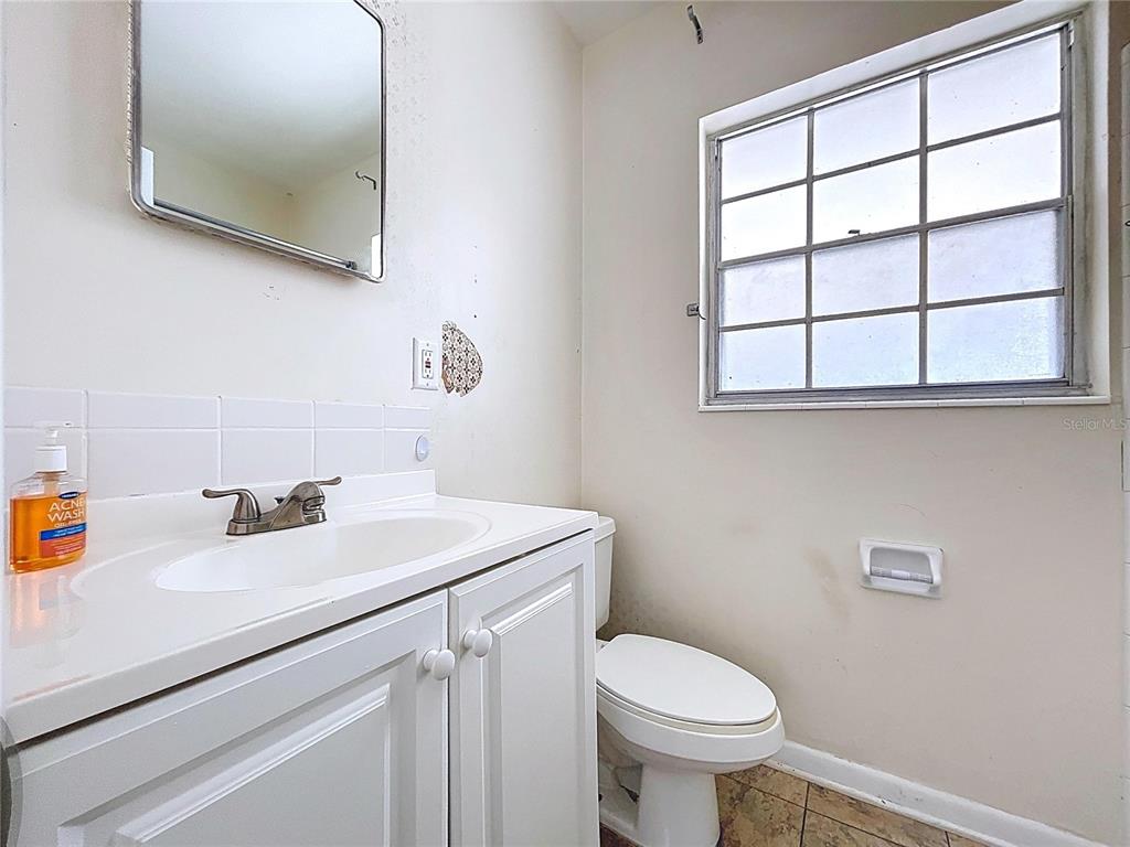 501 Spring Avenue Anna Maria, FL 34216 - Photo 38 of 49 a bathroom with a sink a toilet and a mirror