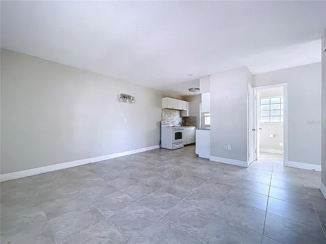 a view of a kitchen with furniture and an empty room