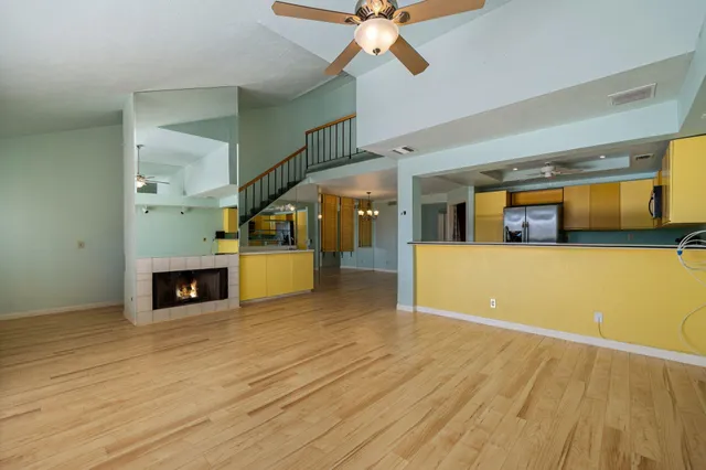 a view of a living room and kitchen with a wooden floor