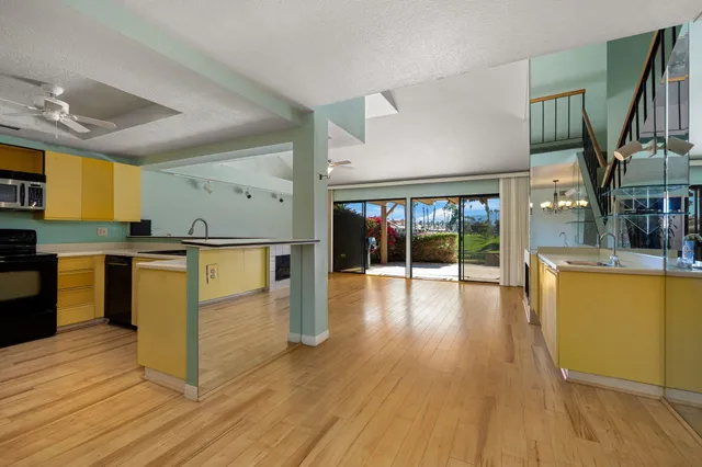 a view of a room with wooden floor and stairs