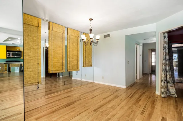 a view of water heater room with wooden floor