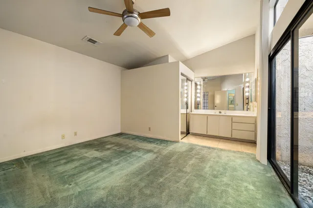 a bathroom with a shower sink and mirror