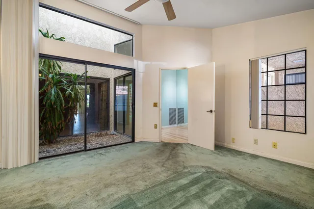 a bathroom with a sink a toilet a mirror a vanity and shower curtain