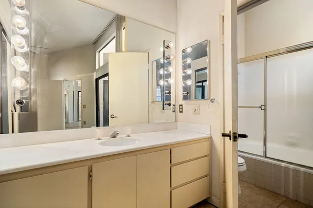 a bedroom with a large bed and a large window with outer view