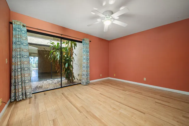 a bedroom with a bed and a mirror on the dresser