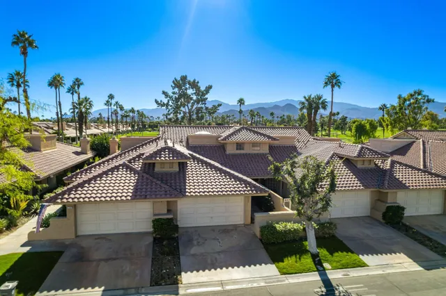 an outdoor view of a house with wooden floor