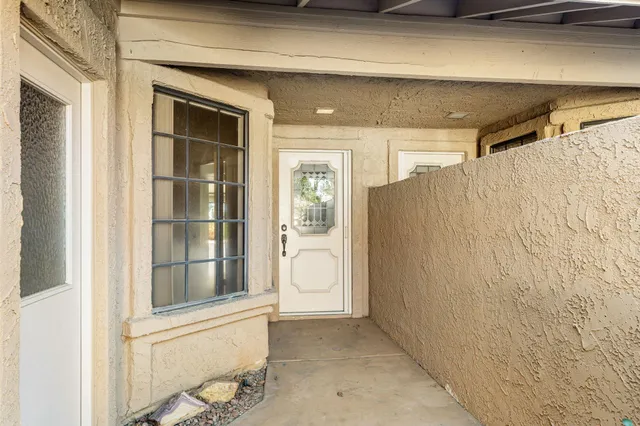 a view of a dining room with furniture large windows and wooden floor