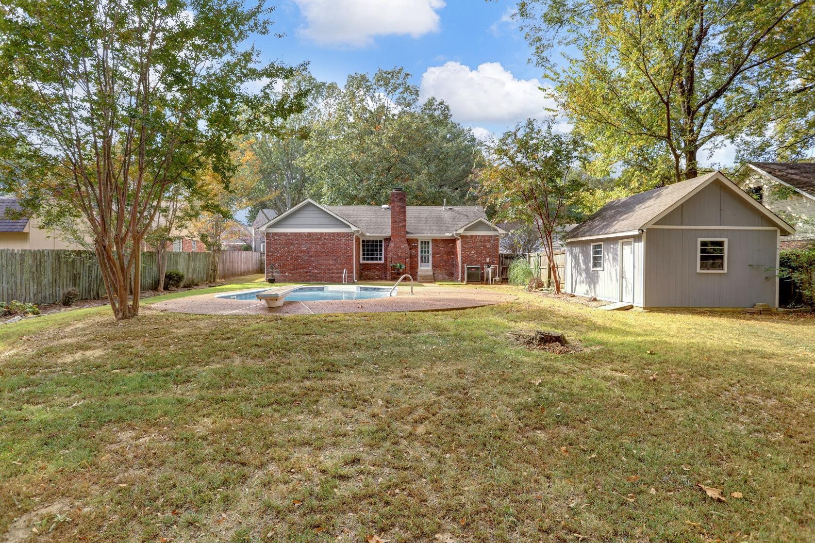 372 Dove Valley Road Collierville, TN 38017 - Photo 30 of 32 a front view of a house with a yard and trees