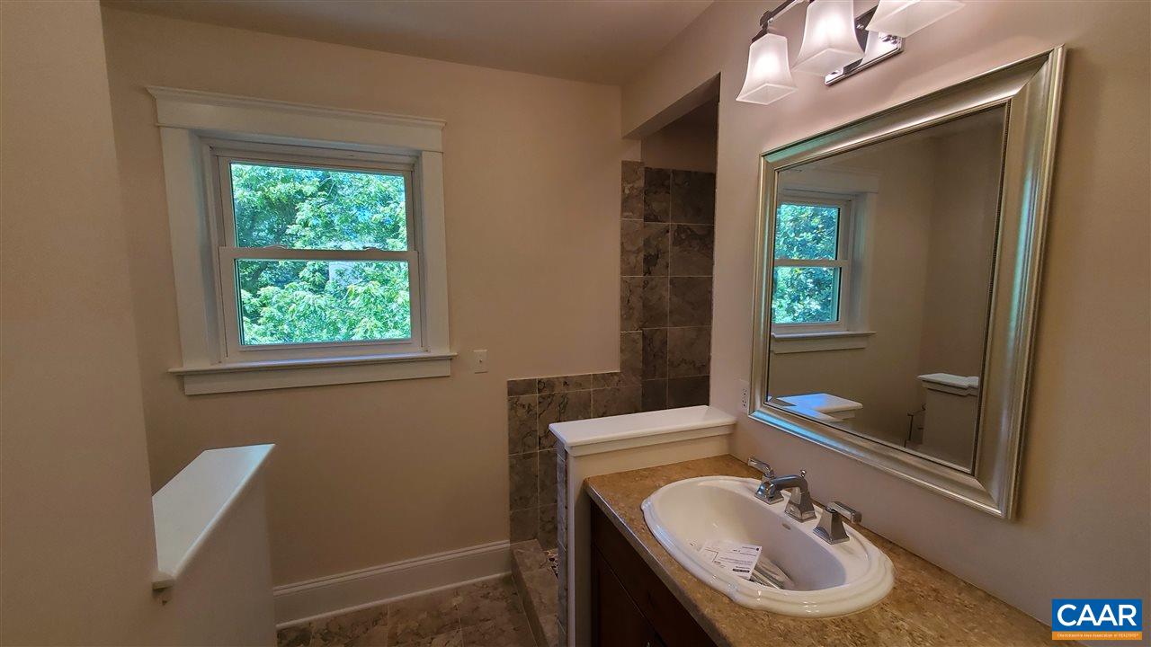 3007 Morgantown Road Charlottesville, VA 22903 - Photo 16 of 30 a bathroom with a granite countertop sink and a mirror