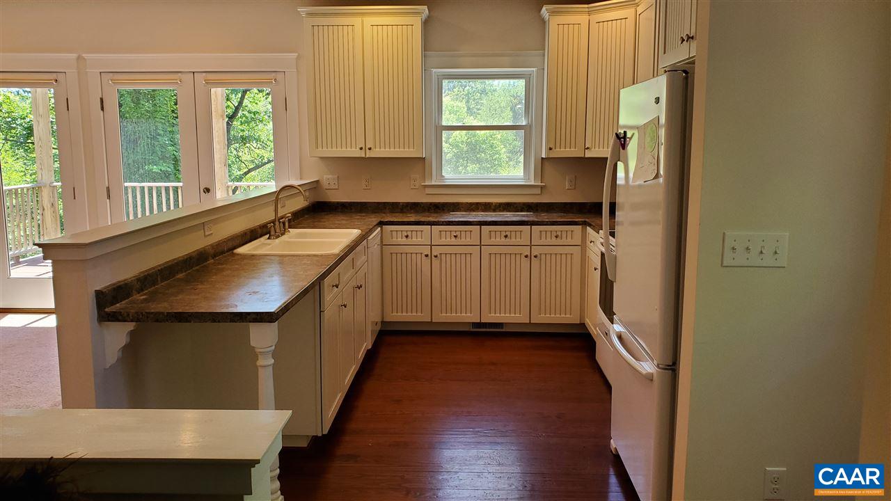 3007 Morgantown Road Charlottesville, VA 22903 - Photo 6 of 30 a kitchen with a sink a counter top space and cabinets
