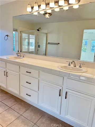 a bathroom with a sink vanity and mirror