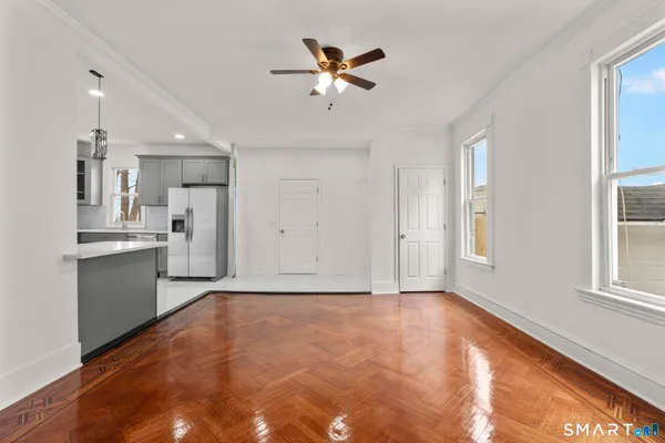 a view of an empty room with a kitchen
