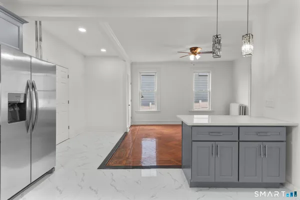 a spacious bathroom with a granite countertop sink a mirror and shower
