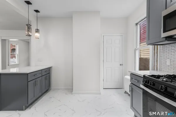 a kitchen with stainless steel appliances a stove and a sink